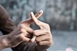 Black man's hands making a sign