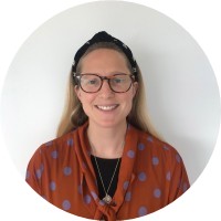 White woman with long fair hair and glasses