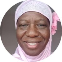 Black woman wearing a pale pink hijab amira