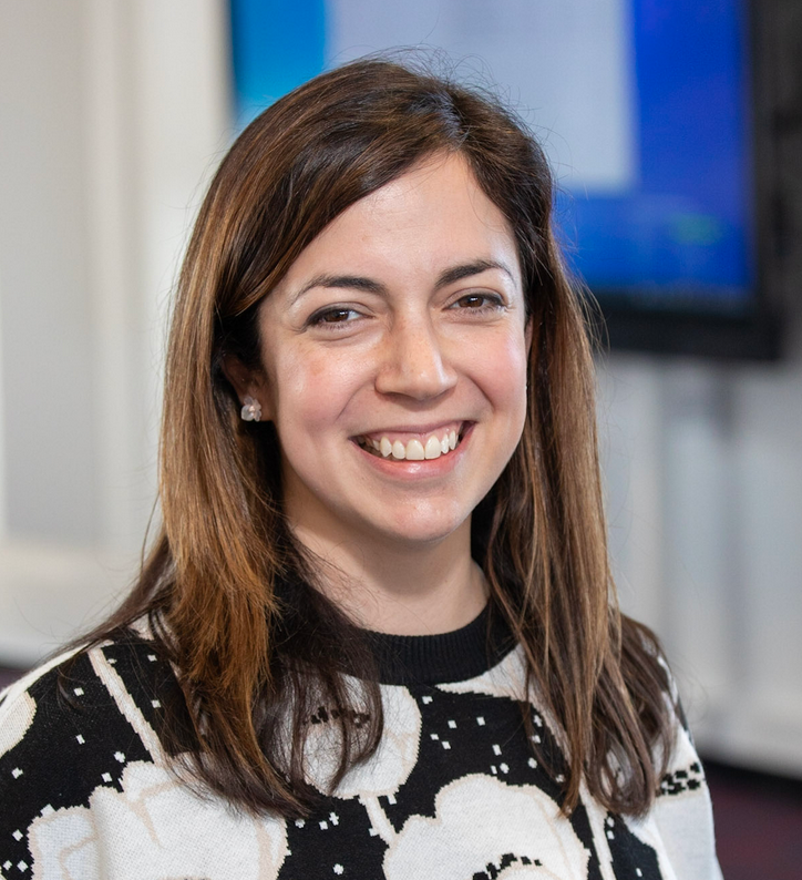 White woman with below the shoulder brown hair