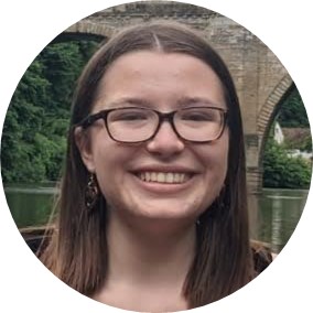 White woman with brown hair and glasses