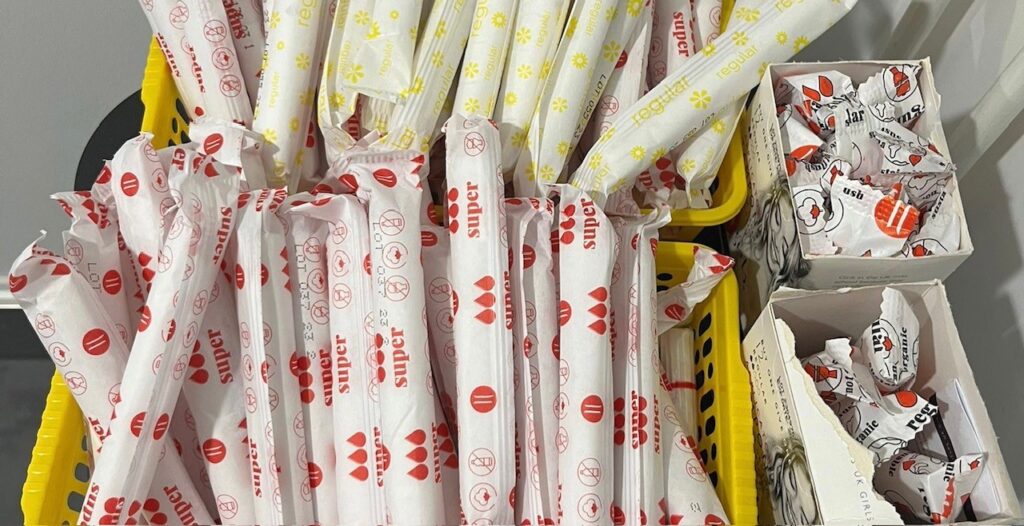 collection of tampons in yellow packaging for regular and red packaging for super