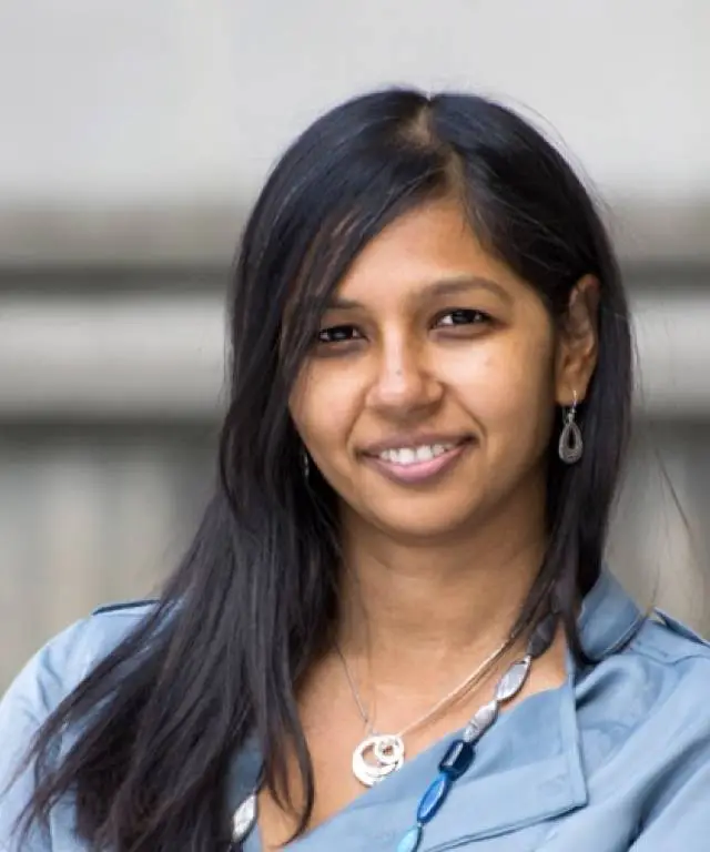 Brown woman with long black hair.