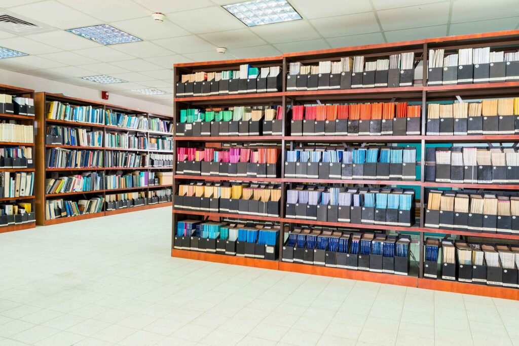 Stock image of university library bookshelves covered in academic journal editions