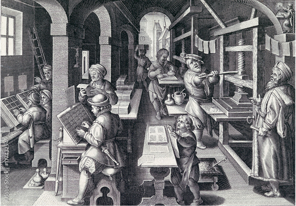 An old lithograph showing a workshop in which there are typesetters, apprentices, and printers using an old Caxton printing press. Pages hang up to dry on lines. Stacks of papers sit on a desk. The dress of the men appears to be Renaissance period.